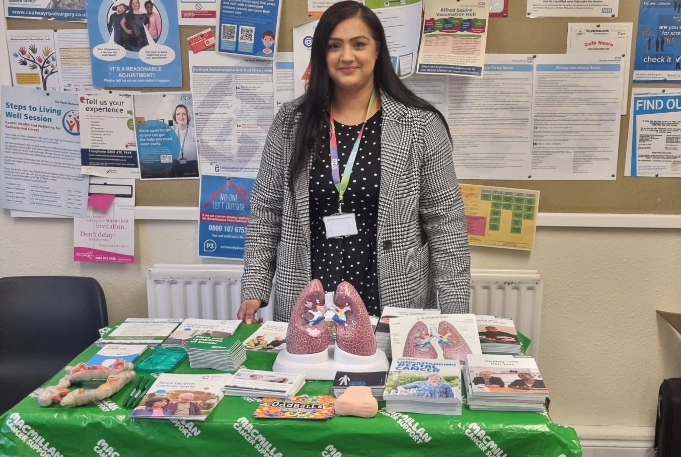 image of cancer champion Raj standing behind display table